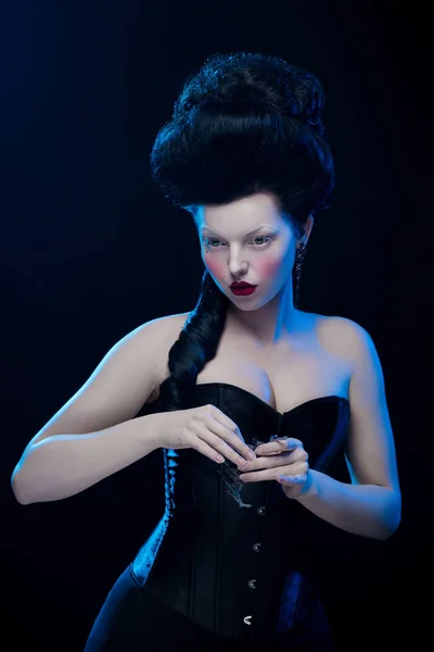 emotional actress brunette woman with pale skin in role of vampire on black background
