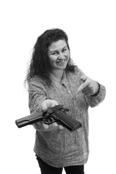 attractive emotional middle aged woman posing with gun isolated on white background