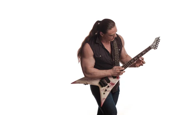 Male musician bodybuilder with long hair and electric guitar  posing and playing on white background