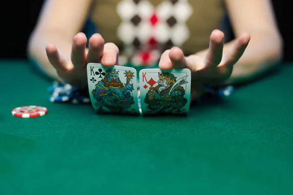 young lady playing solitaire and posing on dark background