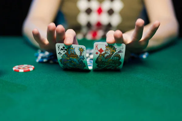 young lady playing solitaire and posing on dark background