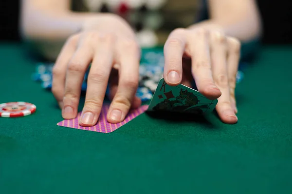 young lady playing solitaire and posing on dark background