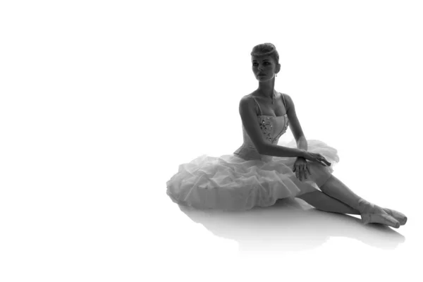 woman ballerina in white pack posing on white background, black and white photo made in the style of \