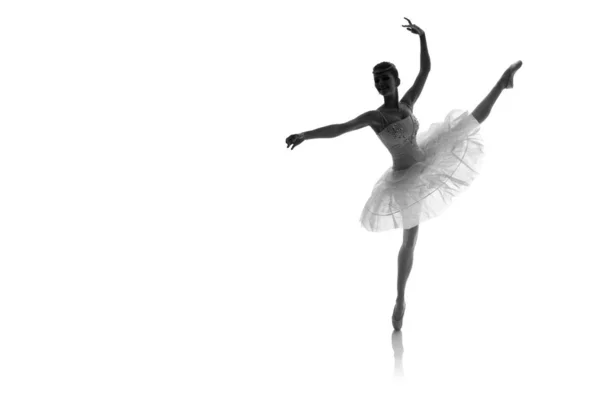 woman ballerina in white pack posing on white background, black and white photo made in the style of 