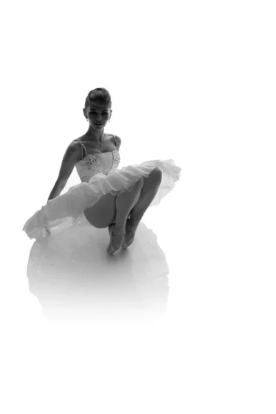 woman ballerina in white pack posing on white background, black and white photo made in the style of \