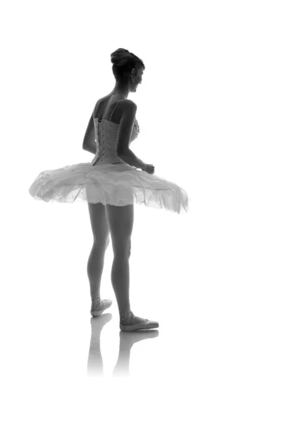 woman ballerina in white pack posing on white background, black and white photo made in the style of \