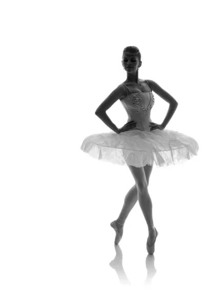 woman ballerina in white pack posing on white background, black and white photo made in the style of \
