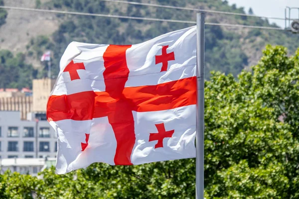 Georgian flag waving on blue sky background
