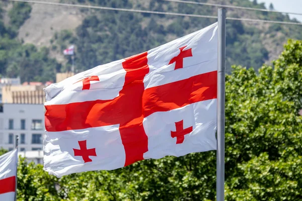 Georgian flag waving on blue sky background