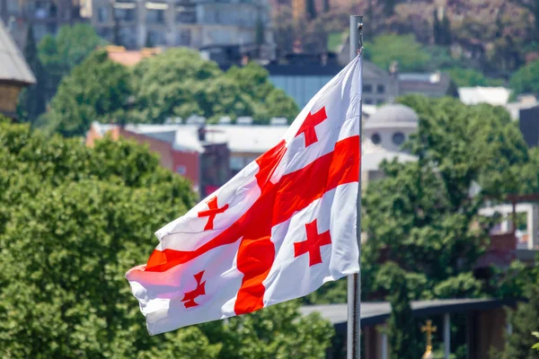 Georgian flag waving on blue sky background