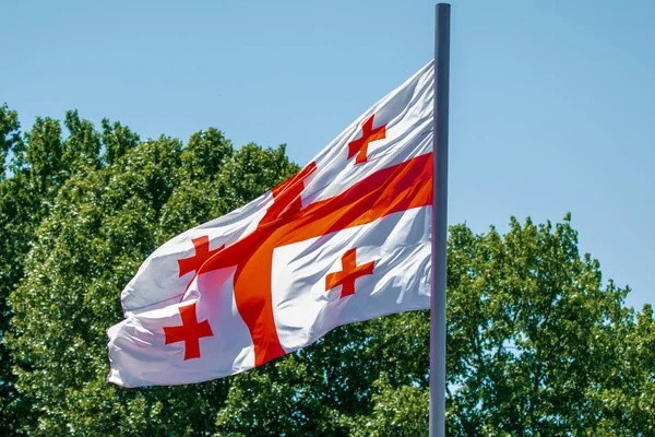 Georgian flag waving on blue sky background