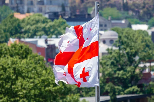 Georgian flag waving on blue sky background