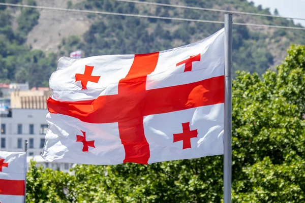 Georgian flag waving on blue sky background