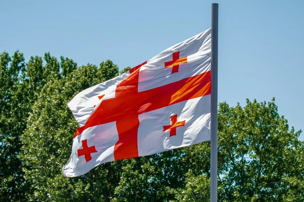 Georgian flag waving on blue sky background