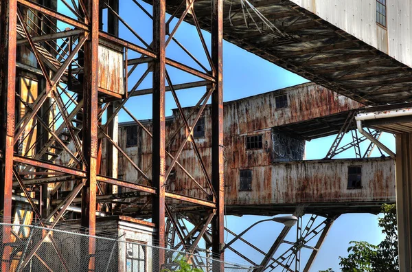 Abandoned rusted industrial structures in old port — Stock Photo, Image
