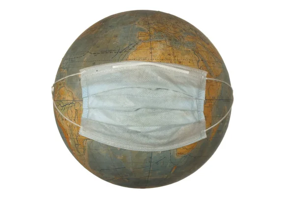 old globe of the Earth with a protective mask isolated on a white background.