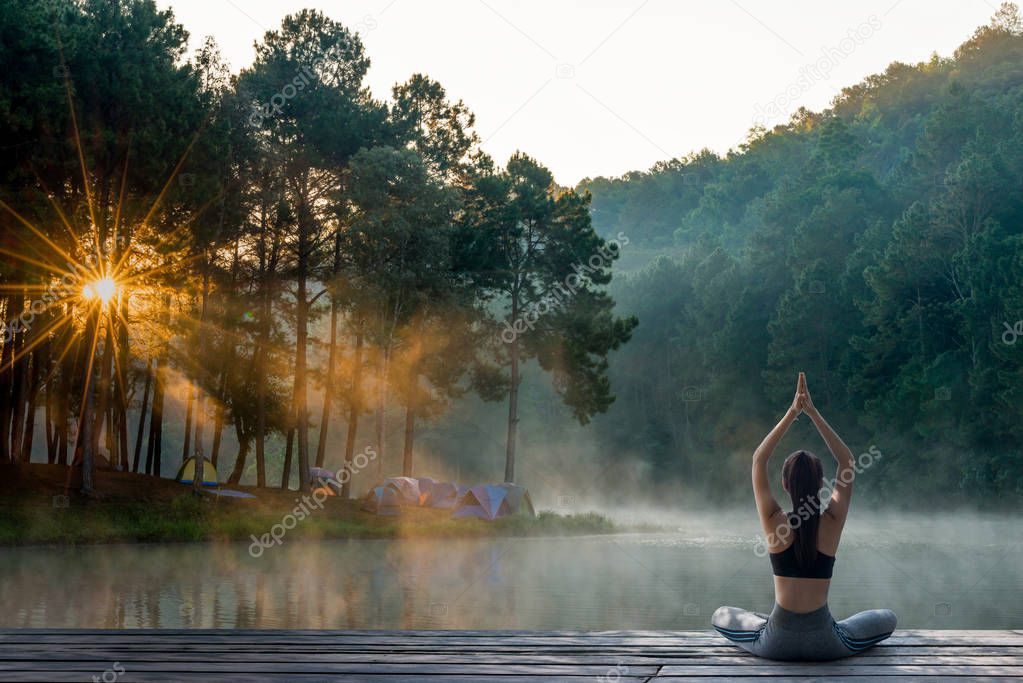 Young woman practicing yoga in the nature