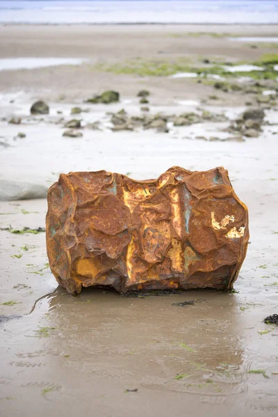 Rusty metal barrel washed up — Stock Photo, Image