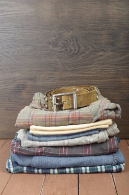 Giysi, Ayakkabı ve aksesuarları - Derma kot ve deri kemer ahşap arka plan üzerinde Grup yığın yığını