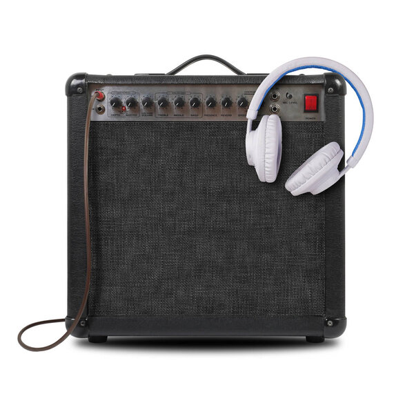 Music and sound - Musical instrument Guitar amplifier, white headphone and cable front view isolated on a white background.
