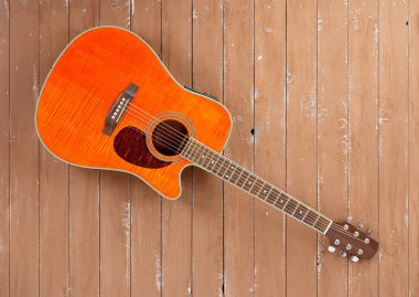 Müzik aleti - turuncu Flame akçaağaç akustik kesit kaplan akçaağaç ahşap gitar mavi ahşap arka plan üzerinde.