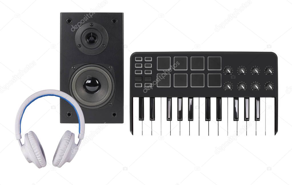 Music and sound - Front view line array loudspeaker enclosure cabinet, MIDI keyboard and white headphone isolated on a white background.