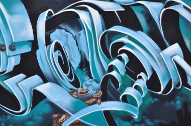 Arka plan olarak duvarda renkli mürekkep ile yapılan bir soyut desen parçası