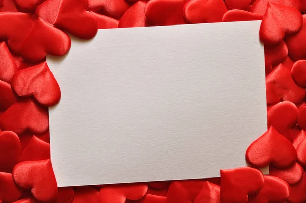 Red hearts and white card — Stock Photo, Image