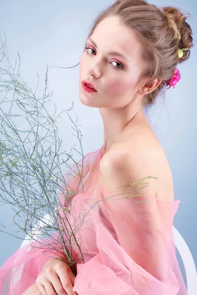 Schönes Mädchen, isoliert auf blauem Hintergrund mit bunten Blumen, Emotionen, Kosmetik — Stockfoto