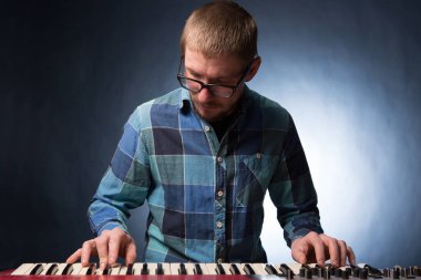 Karanlık arka planda klavye çalan müzisyen. Müzisyen konsepti.