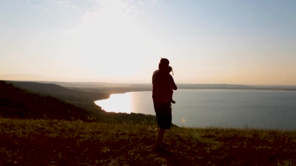 Tata i jego córeczka cieszą się zachodem słońca nad górskim jeziorem.. — Wideo stockowe