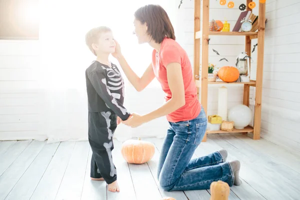 Happy family of mother and children prepare for Halloween in decorate the home — Stock Photo, Image