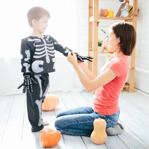 Happy family of mother and children prepare for Halloween in decorate the home — Stock Photo, Image