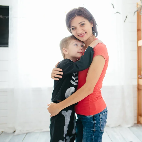 Happy family of mother and children prepare for Halloween in decorate the home — Stock Photo, Image