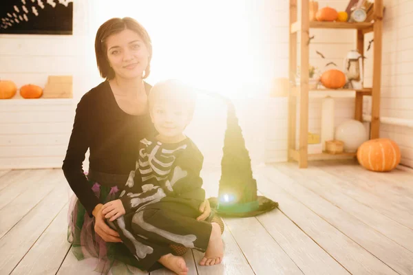 Happy family of mother and children prepare for Halloween in decorate the home — Stock Photo, Image