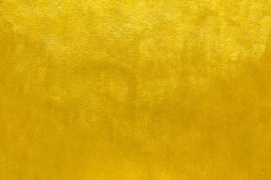 Altın duvar dokusu arka plan. Sarı, parlak, altın renkli duvar boyası. Işık yansımalı, parlak, altın renkli duvar kağıdı kılıfı.