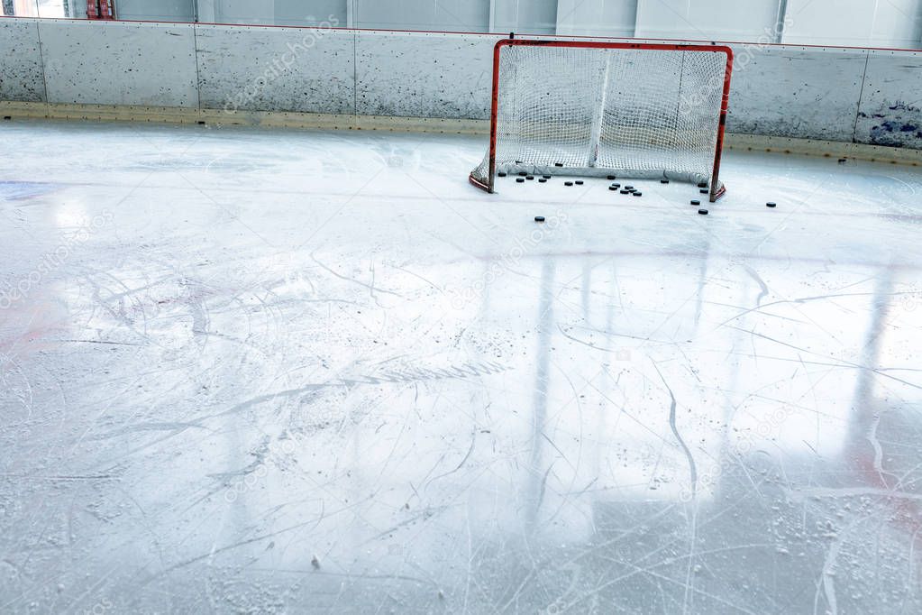 ice hockey ice rink, puck and empty red net