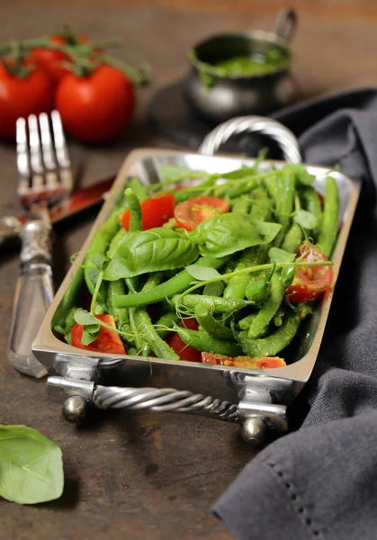 salad of green beans with tomatoes and pesto sauce