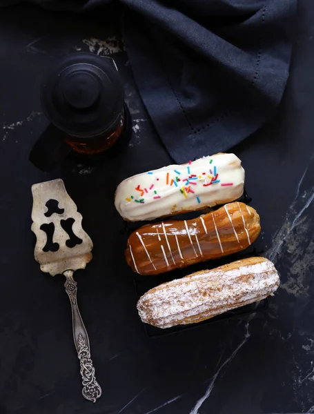 choux pastry eclairs with icing sugar