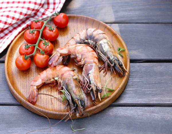grilled shrimp on a plate on a wooden table