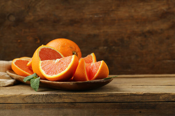 ripe organic red orange on wooden background