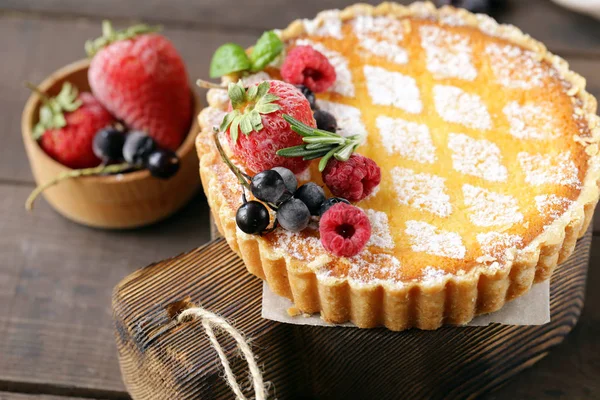 cheesecake with powdered sugar and berries