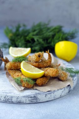 öğle yemeği için kızarmış balık, limon ve otlar ile