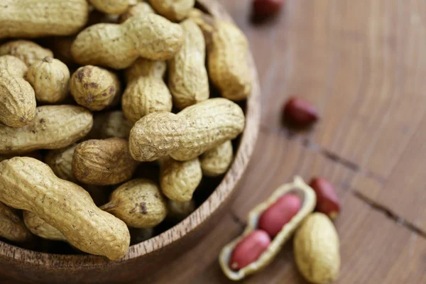 natural organic peanuts on a wooden table