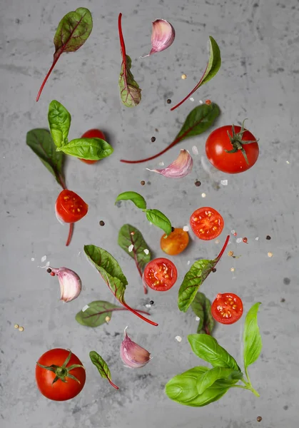 flying vegetables and herbs for salad