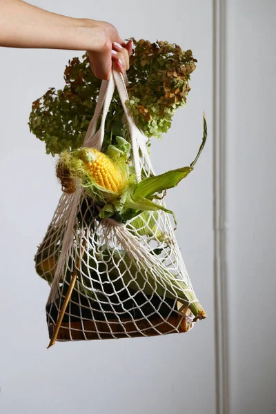 string bag with vegetables and food