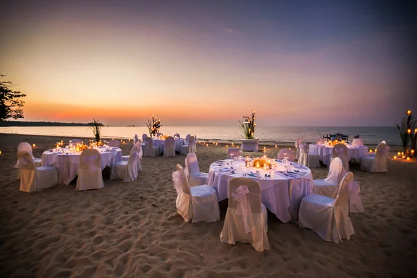 Romantic set up dinner set on the beach.(Selactive focus)