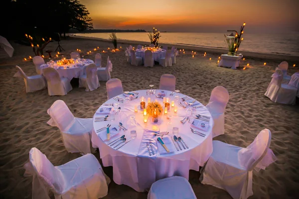 Romantic set up dinner set on the beach.(Selactive focus)