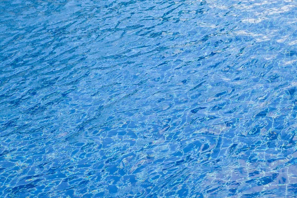 Desenfoque de la luz reflejándose en la piscina azul . — Foto de Stock