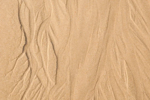 Sand struktur. Sandstrand för bakgrund. — Stockfoto